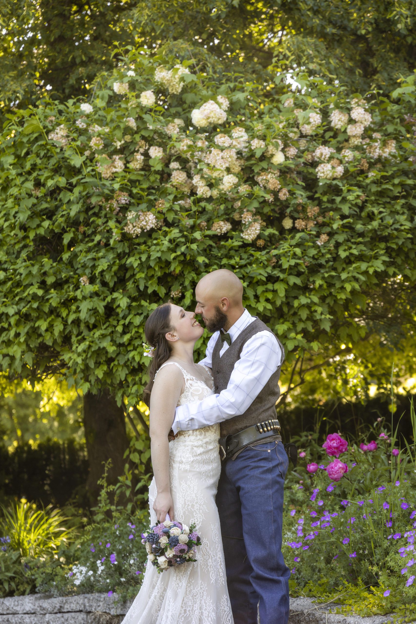 bride and groom sharing a kiss during their rosehurst garden wedding