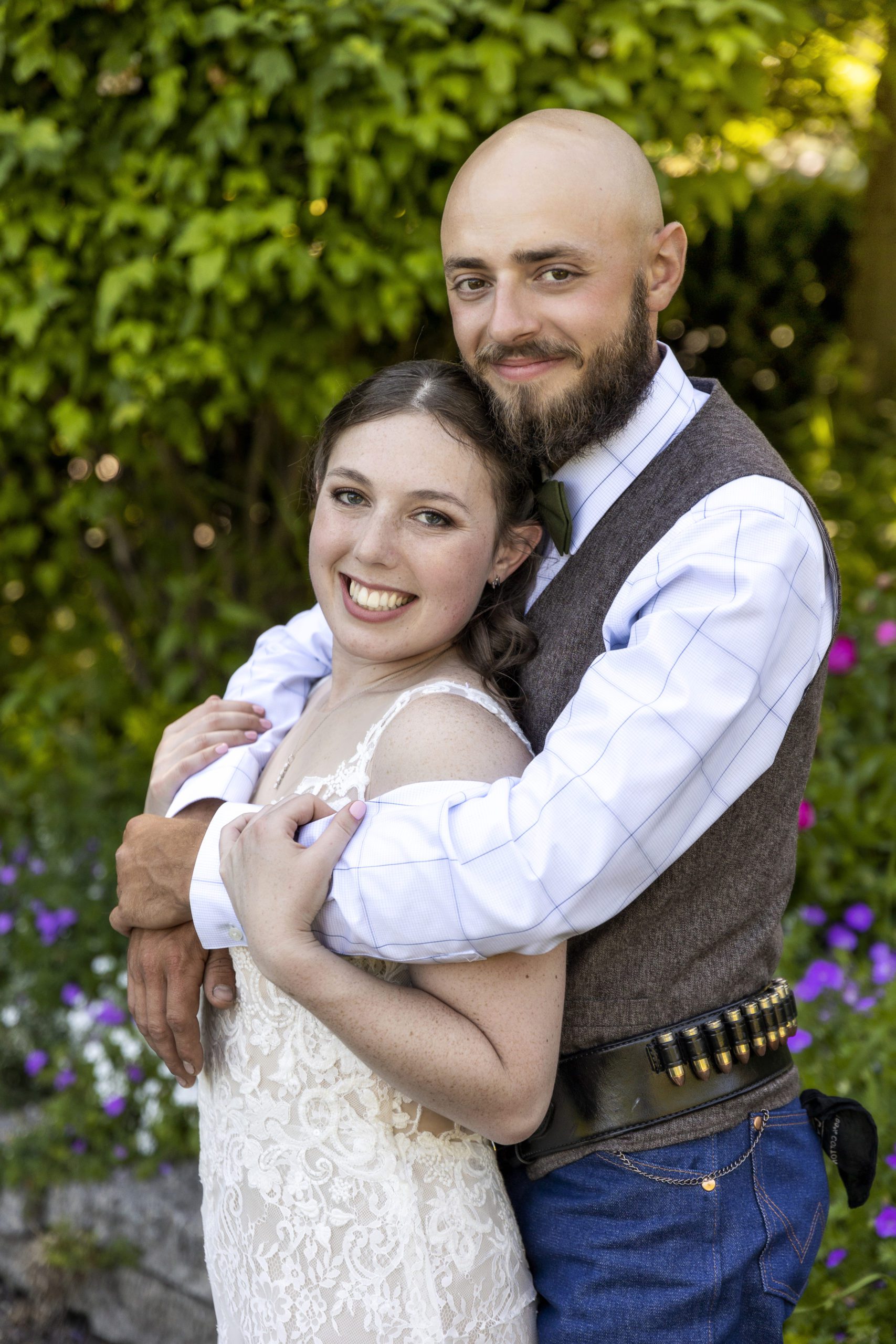 groom holding his bride from behind at their rosehurst garden wedding