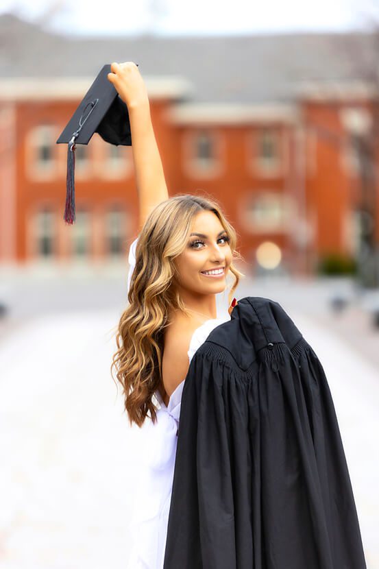 College Graduation Picture Posing Ideas cap in the air with gown over shoulder