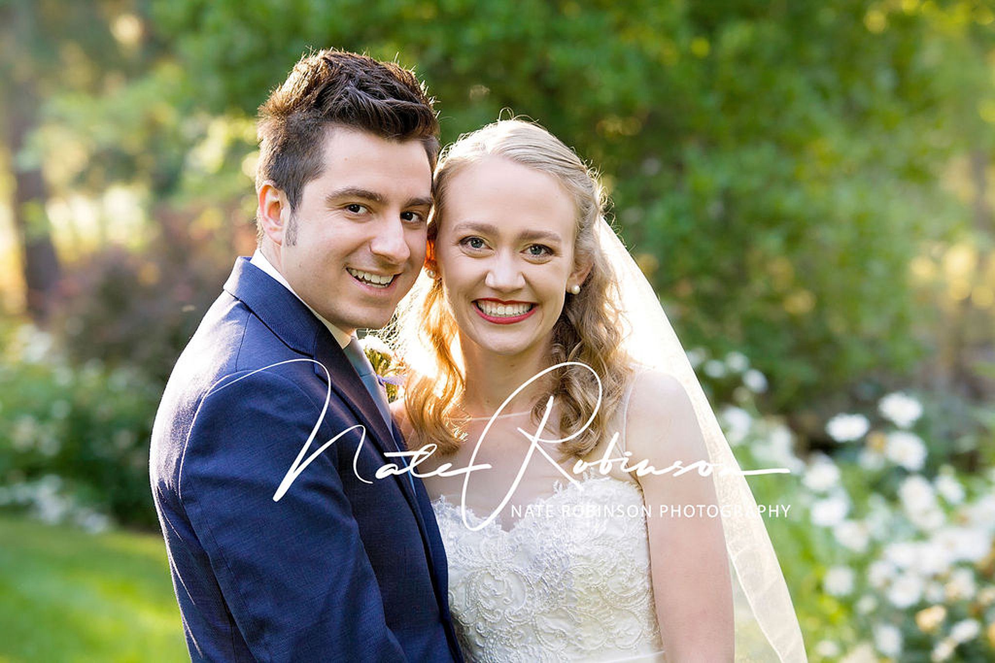 bride and groom with their cheeks together at their manito park wedding