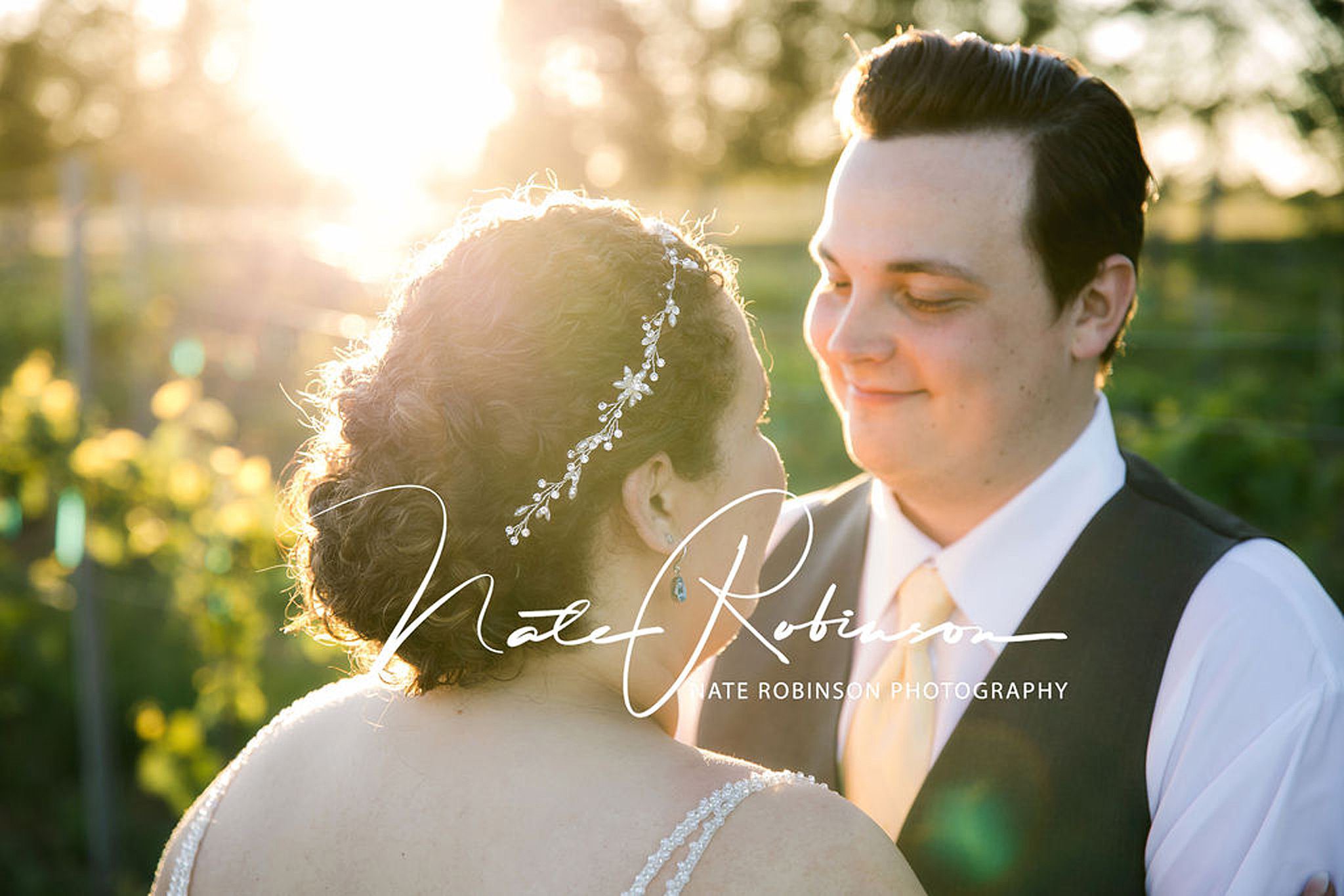 Bride wearing diamond hair piece stands in the sun with groom wearing yellow tie and vest