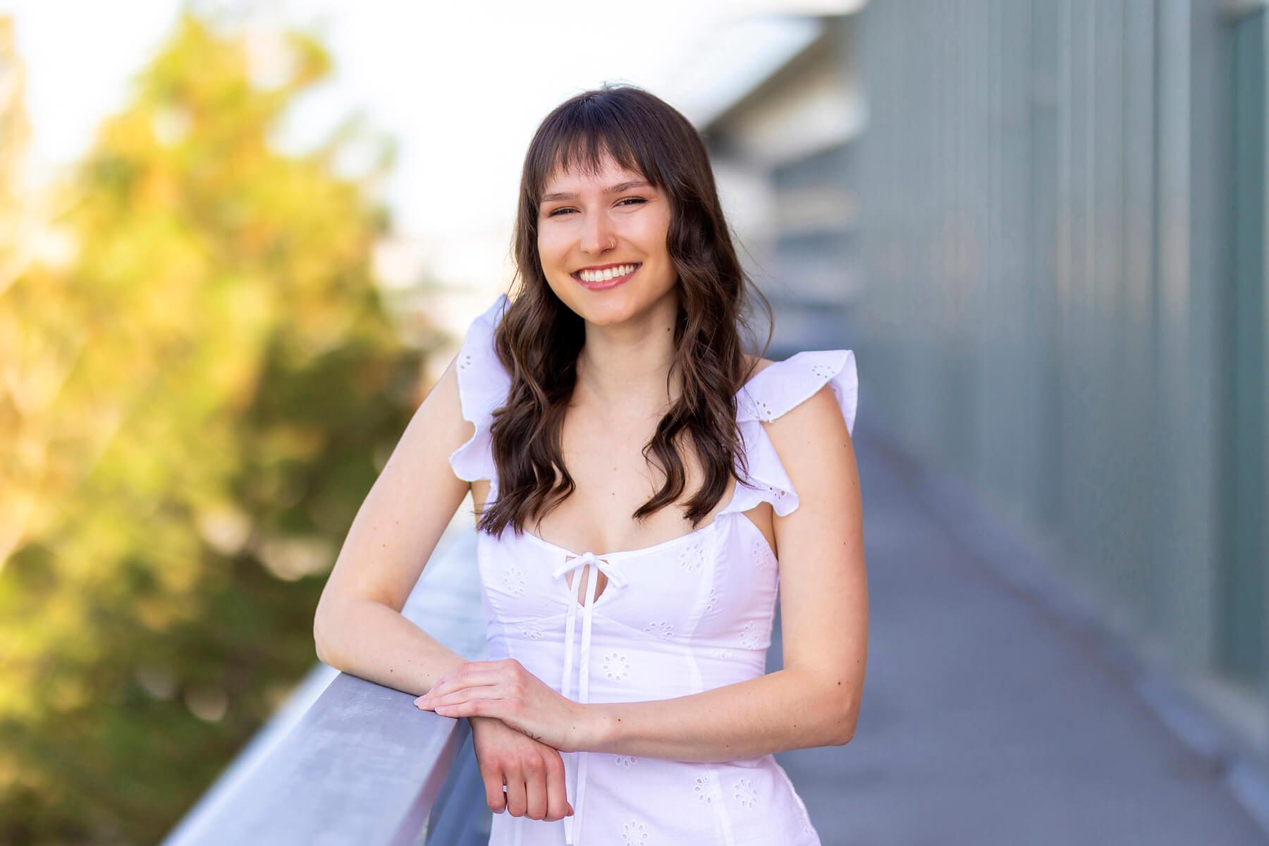 Girl in an urban setting wearing a little white dress