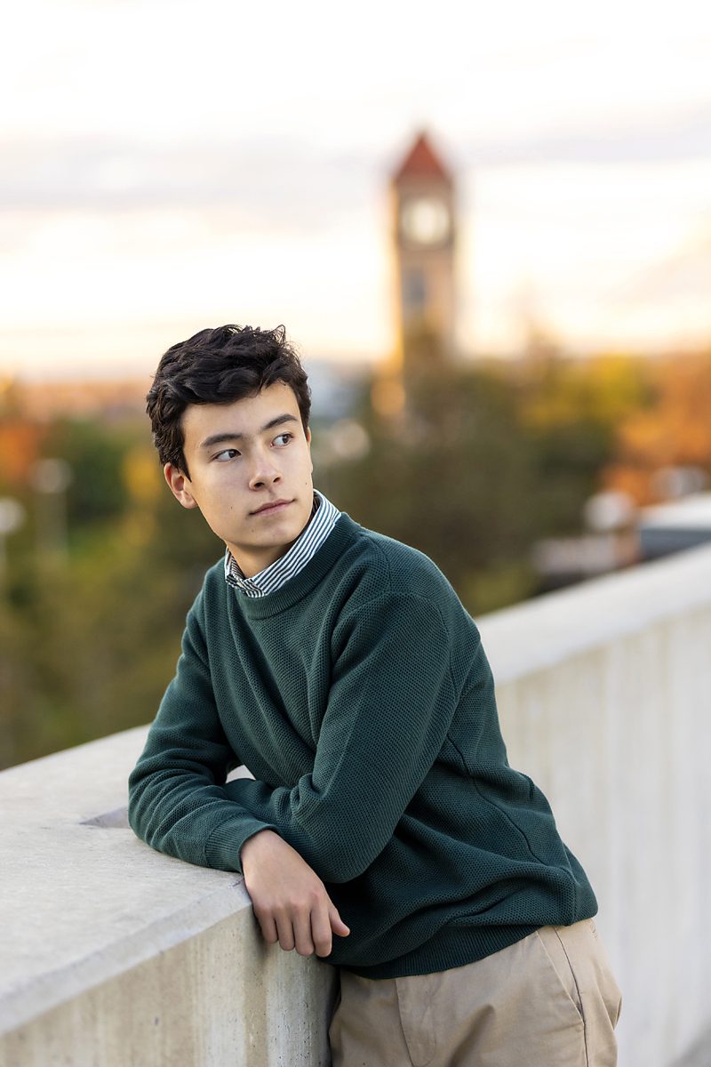 Boy Fall Senior Session on a rooftop in Spokane with riverfront park in the background